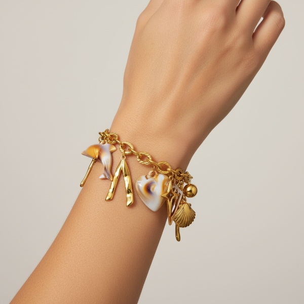 Model wearing gold charm bracelet on wrist