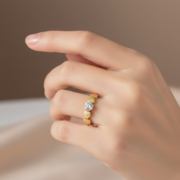 Model wearing gold heart ring - hand close-up