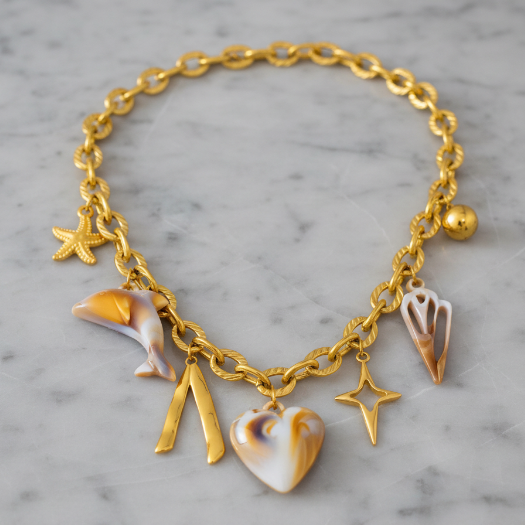 Gold charm necklace angled view